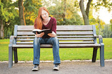 A young lady reading a Bible.