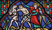 Adam and Eve expelled from the Garden of Eden on a stained glass window.