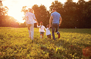 Family running together in a field