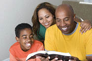 Happy American family reading the Bible.
