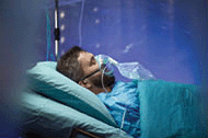 Infected patient in quarantine lying in bed in hospital.