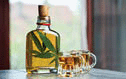 Alcoholic drink infused with a cannabis leaf in the bottle