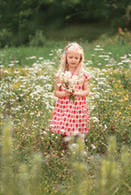 Little girl in a field with wildflowers.