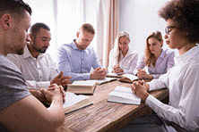 Group Of young multiethnic people reading the Bible.