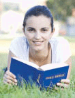 Young girl reading the Bible.