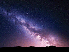 Night landscape with vibrant Milky Way at mountains