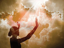 A young girl at sunset praising the Lord.