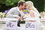 Bride and groom enjoying meal at wedding reception.